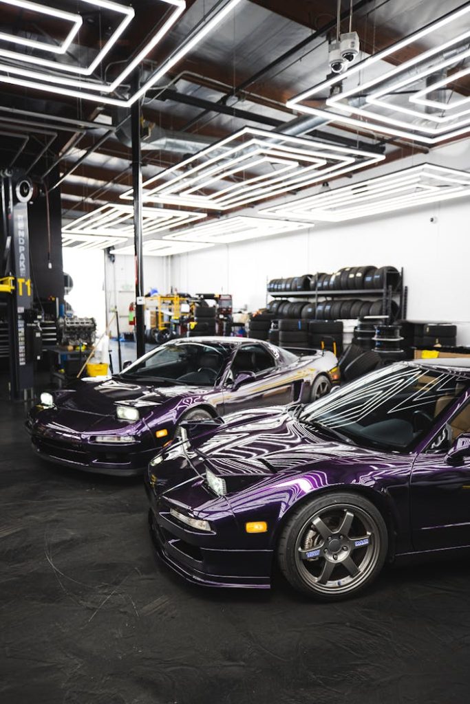 Sleek purple sports cars showcased in a stylish, well-lit garage with modern lighting design.